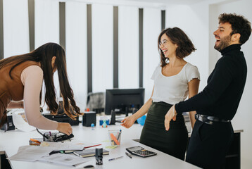 Joyful colleagues laughing and having fun in a modern office setting, promoting teamwork and...