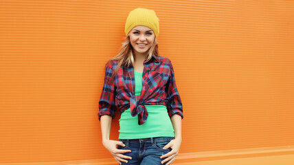 Beautiful happy smiling young blonde woman posing in casual clothes, yellow hat in the city