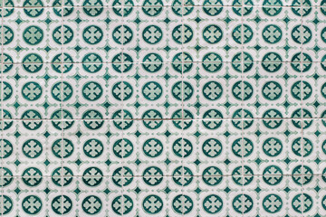 Closeup of decorative floral tiles. Traditional Portuguese ceramic tile pattern, azulejos. Clover. Irish green color. Beautiful facade, wall decoration of old Lisbon building. Portugal. Background.