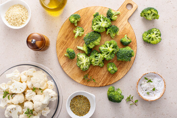 Cooking with broccoli and cauliflower, getting ready to roast vegetables with spices and olive oil - 755236109