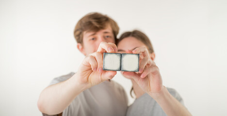 hands with empty cubes. couple showing empty cubes with free space for logo text - 755236114