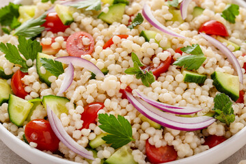 Pearl couscous salad with fresh vegetables and herbs, healthy side dish idea - 755238371