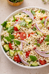 Pearl couscous salad with fresh vegetables and herbs, healthy side dish idea - 755238391