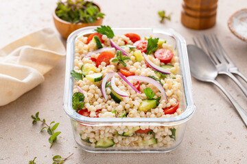 Pearl couscous salad with fresh vegetables and herbs in a meal prep container, healthy lunch or side dish - 755238515