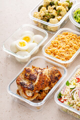 Healthy meal prep with cooked chicken breast, boiled eggs, roasted vegetables, cooked lentils, couscous salad and nuts - 755239994