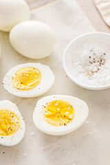 Boiled eggs peeled and cut in half with salt and pepper