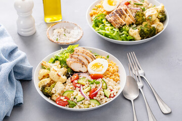 Healthy lunch bowl with grilled chicken, roasted vegetables, fresh lettuce, cooked lentils, salad and boiled egg - 755240785