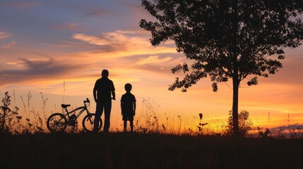 Silhouette in twilight: Father, son, and bicycle against the captivating hues of the evening sky.