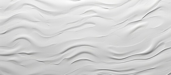 Obraz premium A detailed view of a white wall with subtle wavy lines creating a modern and aesthetic design. The textured surface adds depth and dimension to the space, making it ideal for contemporary interiors.