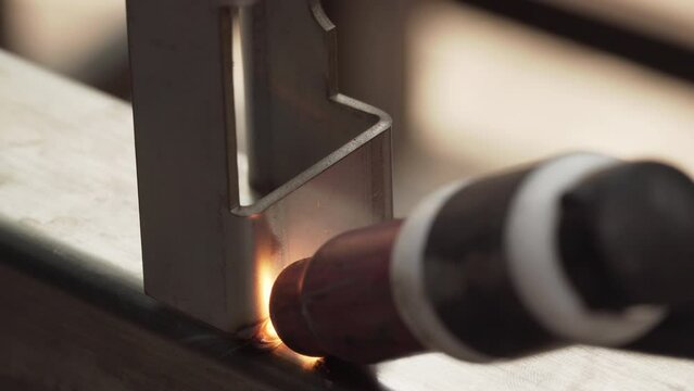 Professional male welder with gas tungsten arc welding (GTAW) or tungsten inert gas (TIG), Closeup shot
