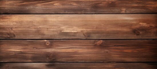 A detailed view of a wooden plank wall with brown boards positioned closely together. The texture of the wood is visible, creating a warm and rustic ambiance.