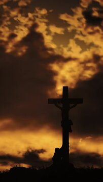 The concept of religious holidays, Easter. Clouds fly over Mount Golgotha, where we can see the cross on which Jesus was crucified. During sunset, the sky glows red-yellow, as if surrounded by fire.