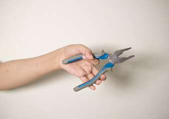 hand is holding a pliers on a white isolated background