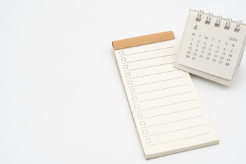 Blank Check list or Empty small notepad with checkbox and Simple desk calendar for APRIL 2024. Blank checklist for text. Copy Space.