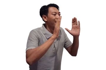 Shocked Asian man wearing gray t-shirt is pointing at the copy space beside him, isolated by white background