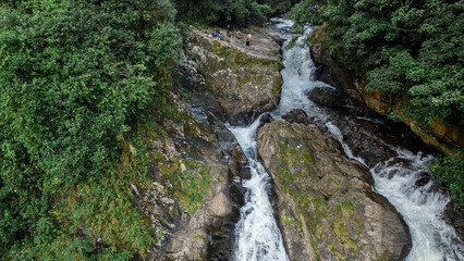 landscape of a huge waterfall in the middle of the jungle of Costa Rica surrounded by vegetation in...