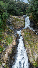close-up of a huge waterfall in the middle of the jungle of Costa Rica surrounded by vegetation in the Barbilla National Park in indigenous territory