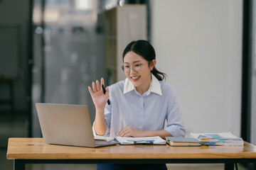 Beautiful young businesswoman working and have an online meeting with her team.