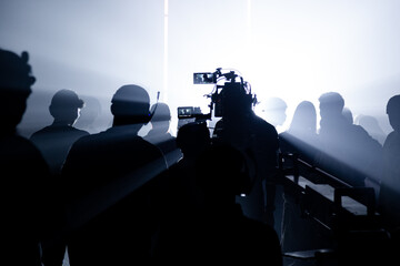 Shooting studio behind the scenes in silhouette images which film team working for movie or video