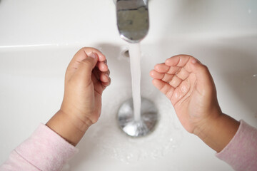 child washing hands with soap 
