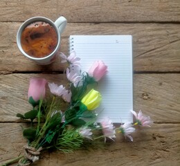 cup of coffee with flowers and book