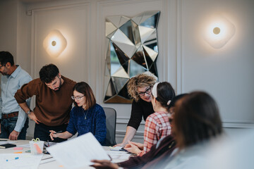 Mixed race, business team collaborating in business meeting at modern office.