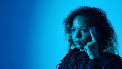 Black woman operating smart glasses