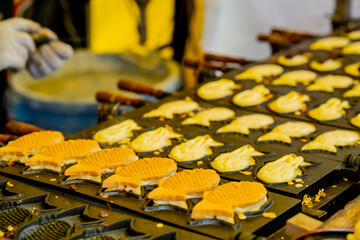 Japanese casual street food snack. Taiyaki. Red bean paste filling. a fish shaped pancake filled with bean jam.