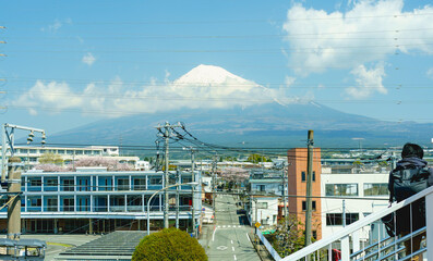 Fuji mountain with clouds and blue sky view from bridge see city, road and beautiful cherry...