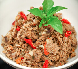 Spicy Shredded Tuna Fish is an Indonesia food. It is from smoked fish, chillies, spices and herbs. White background. Selective focus.
