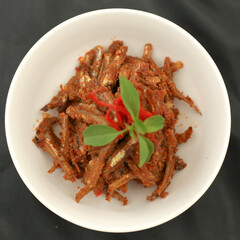 Sambal balado teri is fried anchovy with hot and spicy chili sauce.Traditional Indonesian food. Close-up.
