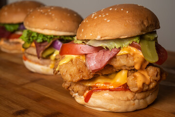 Assorted Burgers with Crispy Chicken Cheese burger with beef bacon isolated on wooden table top view of frech fastfood