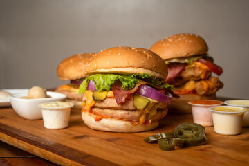 Assorted Burgers with Crispy Chicken Cheese burger with beef bacon isolated on wooden table top view of frech Junk fastfood