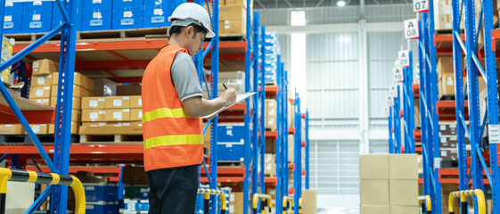 Asian male factory inspect goods in warehouse or inventory and check stock product. Transport...