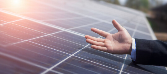Close-up of businessman's hands checking the operation of the sun and the cleanliness of the solar...