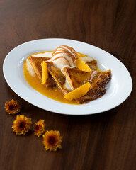 Delicious pancakes with hot sauce and ice cream, garnished with fresh fruits.