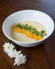 Grain porridge beautifully garnished with fresh fruits.