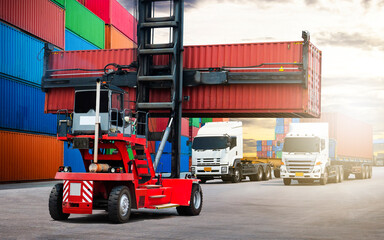 Container Crane Tractor Lifting up Container Box and Trailer Trucks. Handling of Logistics Transportation Industry. Cargo Container ships, Freight Truck Import-Export. Distribution Warehouse Shipping.
