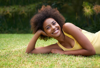 Happy, grass and portrait of black woman in garden for relaxing, calm and peace in park. Smile, nature and person laying outdoors for holiday, vacation and weekend for wellness, fresh air and joy