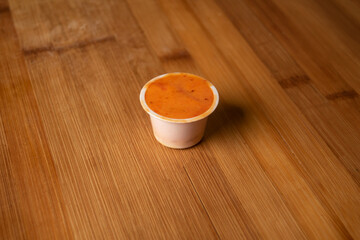 Special Hot Dip chilli sauce served in cup isolated on wooden table top view of indian food