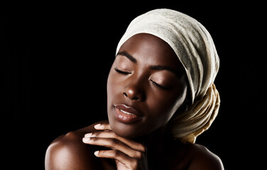 Beauty, relax and black woman with head wrap, natural makeup or creative aesthetic in studio mockup. Art, skincare and African girl on dark background with scarf, facial cosmetics and confidence.