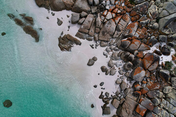 Aerial view of the Taylors beach, bay of fires in Tasmania. Beautiful coastline with orange and grey rocks, white sand and transparent blue water. Drone footage in Australia. - Powered by Adobe