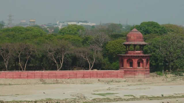 Taj Mahal in Agra, Uttar Pradesh, India. Mehtab Bagh - Moonlight Garden - is a charbagh complex in Agra, North India. It lies north of the Taj Mahal complex and the Agra Fort on the opposite side of