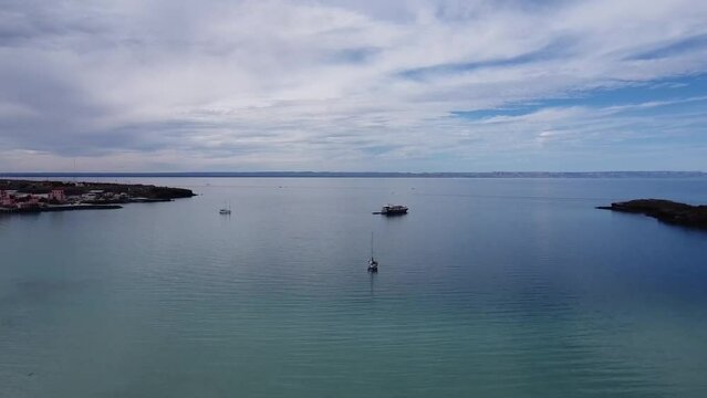 Tranquil view of Playa Pichilingue in Baja California, boats floating on calm waters, serene seascape
