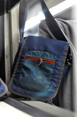 sling bag on the train window