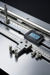 Close-Up View of Various CM Measurement Tools: Stainless Steel Ruler, Flexible Measuring Tape, and Digital Caliper