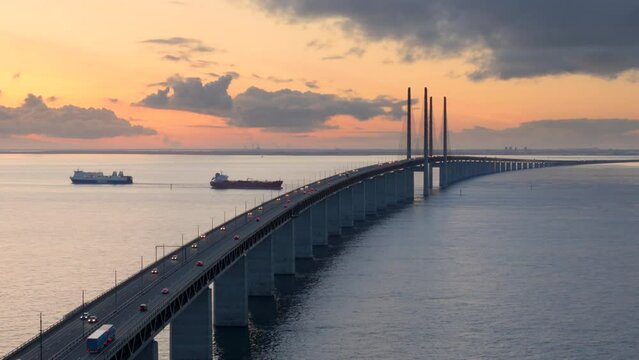 Traffic over Oresund bridge at twilight connecting Denmark and Sweden. Aerial