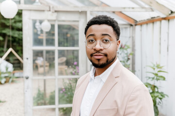 Confident Young Entrepreneur at Stylish Greenhouse Office