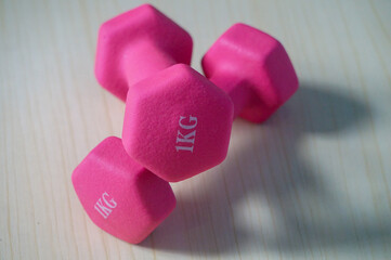 Two pink 1kg dumbbells. Weights for a fitness training.