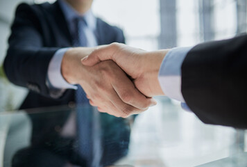 Real estate broker agent Shake hands after customer signing contract document for ownership realty...